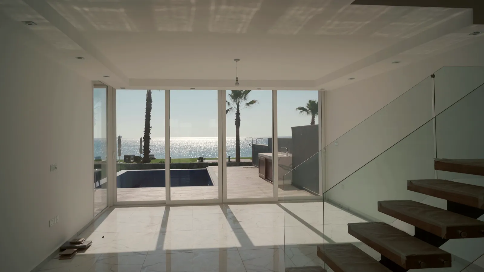 A finished living space with a floating staircase